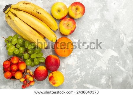 top view fresh yellow bananas mellow and delicious fruits with grapes apples on light-white desk fruit fresh mellow tropical Royalty-Free Stock Photo #2438849373