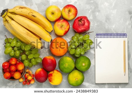 top view fresh yellow bananas mellow and delicious fruits with fresh grapes apples on light-white desk fruit fresh mellow tropical Royalty-Free Stock Photo #2438849383