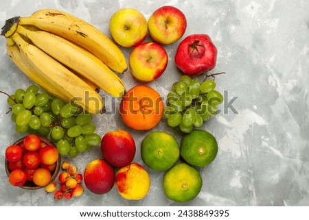 top view fresh yellow bananas mellow and delicious fruits with grapes apples on light white desk fruit fresh mellow tropical Royalty-Free Stock Photo #2438849395