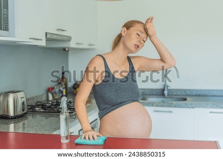A tired pregnant woman sits in the kitchen after cleaning. Health and vitality of a pregnant woman