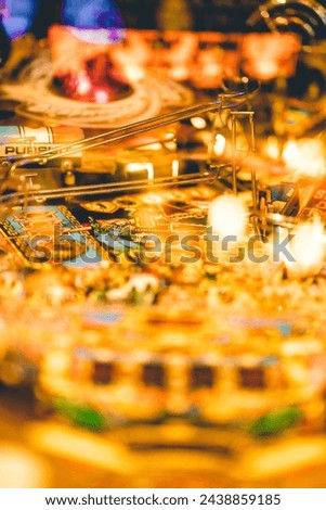 Close-up of an illuminated pinball machine playfield Royalty-Free Stock Photo #2438859185