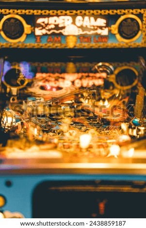 Close-up of an illuminated pinball machine playfield Royalty-Free Stock Photo #2438859187