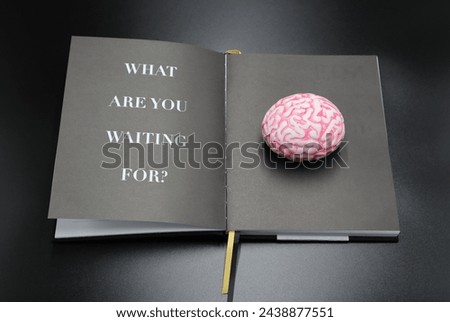 What are you waiting for printed on a page inside of a open lifestyle book start something new and create new brainy ideas for your life Royalty-Free Stock Photo #2438877551