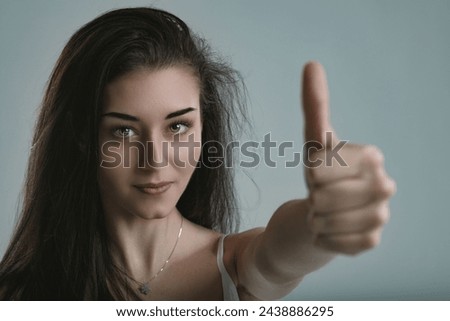 Assurance and positivity emanate from her, as her thumbs-up reflects a winning spirit Royalty-Free Stock Photo #2438886295