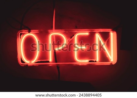 red neon open sign in an industrial setting 