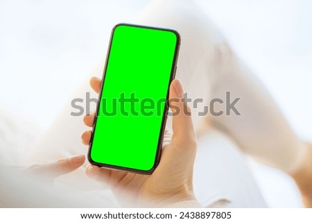 smartphone with green screen in hand