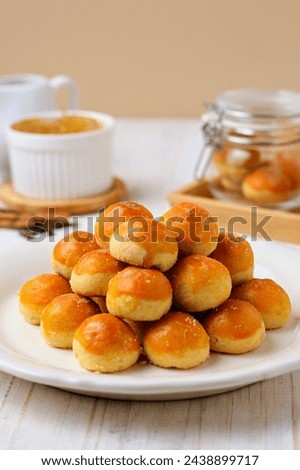 Kue nastar or pineapple tart. indonesian eid snack (kue lebaran). on a white plate. bright mood style. perfect for recipe, article, catalogue, or any commercial purposes. Royalty-Free Stock Photo #2438899717