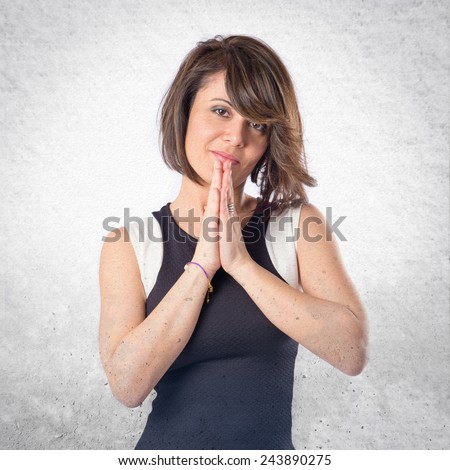 woman in black clothes pleading over textured background 