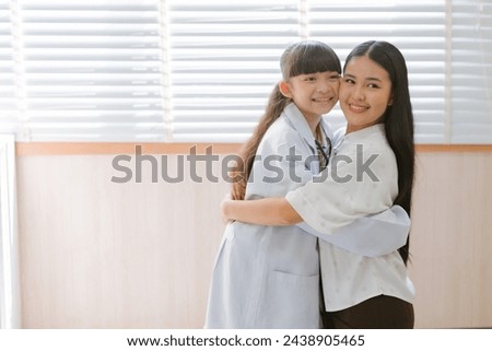 Doctors encourage young girls who dream of becoming doctors by wearing uniforms and giving hugs and clapping their hands in encouragement.