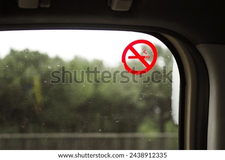 No smoke sign on car window 