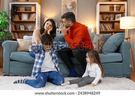 Divorce And Domestic Violence. Portrait of upset son and daughter while their angry parents fighting in the background, depressed children feeling lonely