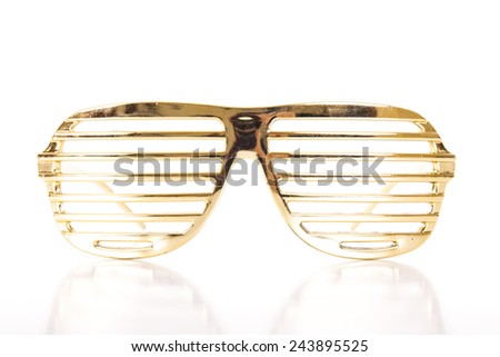Gold glasses on white background Royalty-Free Stock Photo #243895525