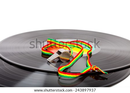 whistle with striped cord on two vinyl records, copyspace