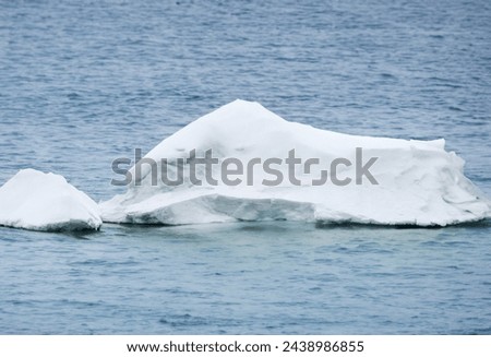 Massive glacial iceberg drifts in Jokulsarlon lagoon's icy water