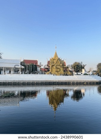Thai temple next to the river and canal Royalty-Free Stock Photo #2438990601