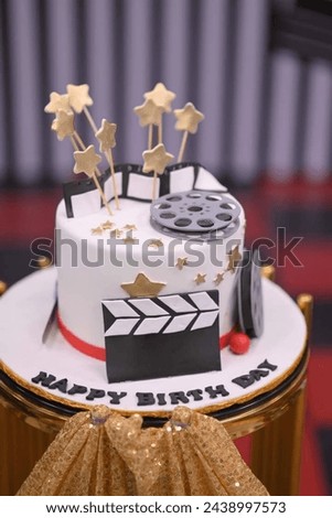 The image shows a cake decorated with a graduation cap and gown. Tags include cake, birthday cake, cake decorating, dessert, and more.