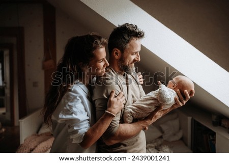 Parents holding newborn baby. Unconditional paternal love, Father's Day and Mather's Day concept. Royalty-Free Stock Photo #2439001241