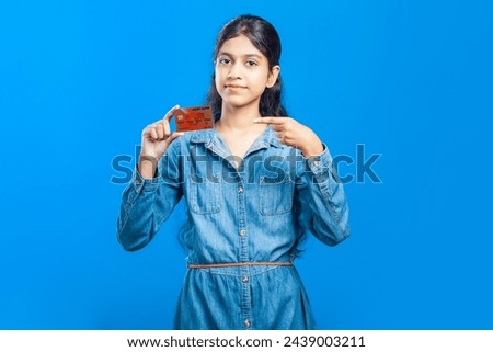 Caucasian girl pointing finger towards debit card