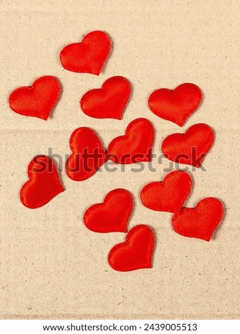 Scattered Red Hearts on the Cardboard Background closeup