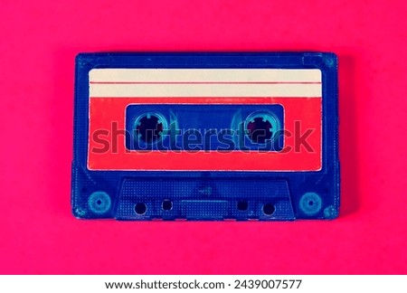 Toned Photo of Old Audio Cassettes on the Pink Background closeup
