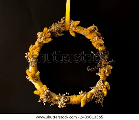 wreath of yellow flowers on a black background
