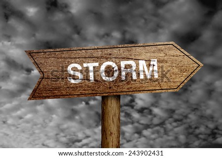 Storm wooden road sign with dark cloudy sky background.