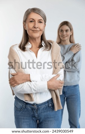 Good-looking mature well-groomed woman with her daughter