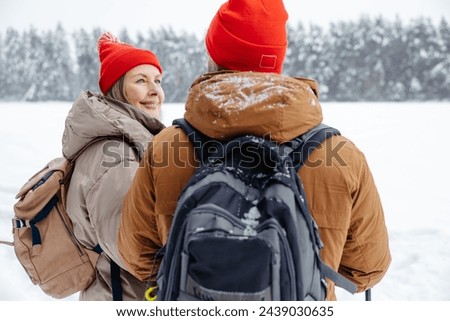 Waist up picture of a mature couple on a winter background
