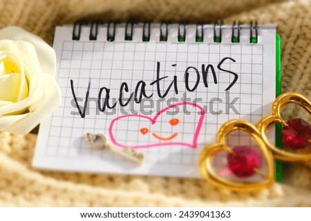 Text Vacations on paper, notepad and rose flower, key, heart. Motivation. Love. Travel. Atmospheric mood. Honeymoon Royalty-Free Stock Photo #2439041363