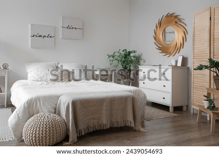 Stylish interior of modern bedroom with cozy bed