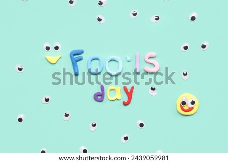 Test FOOLS DAY with fake eyes on turquoise background