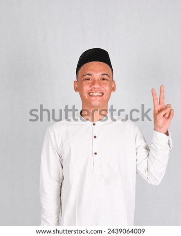Asian young man excited and pointing up