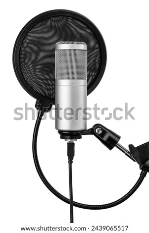 Studio microphone on the adjustable stand with a pop filter, ready for an audio recording. Isolated on a white background.
