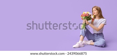 Pretty young woman with bouquet of beautiful tulips sitting against lilac background with space for text