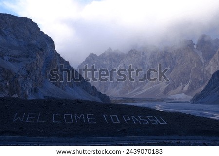 The sign "Welcome to Passu" written on the foot of a mountain in Passu Valley, in Gilgit-Baltistan in northern Pakistan.