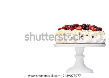 Meringue Pavlova cake with whipped cream and fresh berries isolated, strawberries and blueberries on white background. Horizontal orientation
