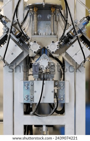 Close up of automatic desiccant filling machine. Desiccant filling machine fills spacer frames with desiccant drying agent for production of insulated glass units. Selective focus. Royalty-Free Stock Photo #2439074221