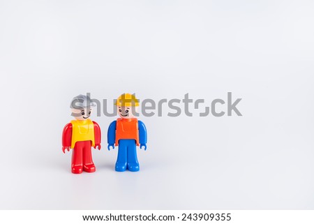 Miniatures of construction workers isolated on white background 