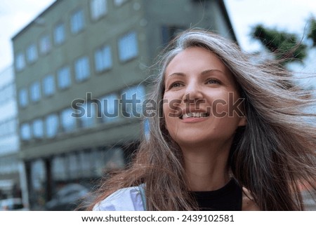 portrait of a smiling woman in a modern city. High quality photo
