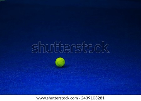 green Tennis ball and blue court 