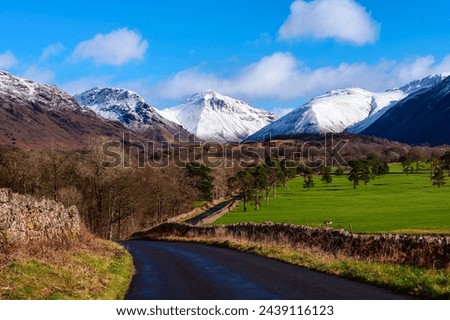 The snow covered mountains of Wasdale Head from the Old Post Office road from Santon Bridge through Nether Wasdale. Royalty-Free Stock Photo #2439116123