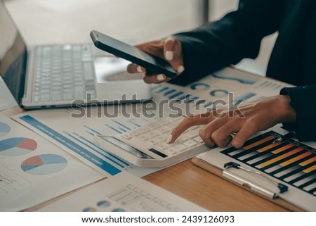 Young Asian male businessman is pressing a calculator to calculate income, taxes and expenses, credit card bill for payment or payday at home. Close-up pictures