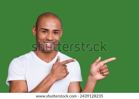 Close up photo healthy masculine dark skin he him his macho bald head eyes arms fingers point to empty space show low cool cheap prices wearing white t-shirt outfit clothes isolated grey background