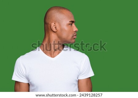 Close up photo amazing dark skin he him his man head turned to empty space distracted smart clever eyes shiny shaved face wearing white t-shirt outfit clothes isolated on grey background