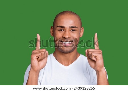 Close up photo healthy masculine dark skin he him his macho bald head arms fingers raised up to empty space show new price list wearing white t-shirt outfit clothes isolated grey background