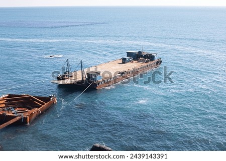 Picture of a large barge. barge with the cargo on the sea.