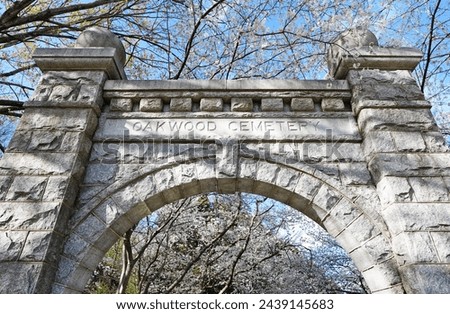 Historic Oakwood cemetery entrance and Spring trees in bloom in Raleigh North Carolina                                Royalty-Free Stock Photo #2439145683