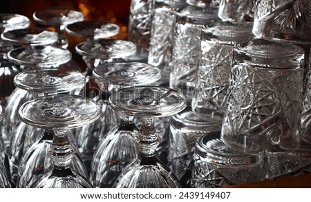 Rows of Glasses Set Out on Bar. Royalty-Free Stock Photo #2439149407