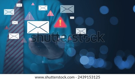 Businessman holding a smartphone with alert Email inbox and spam virus with warning caution for notification on internet letter security protect, junk and trash mail and compromised information.