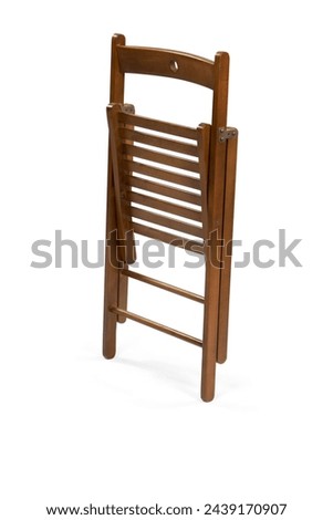 Wooden folding chair isolated on white background . Royalty-Free Stock Photo #2439170907